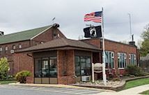2 flags flying in front of a municipal building
